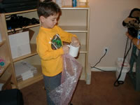 Justin wraps the mug in bubble wrap